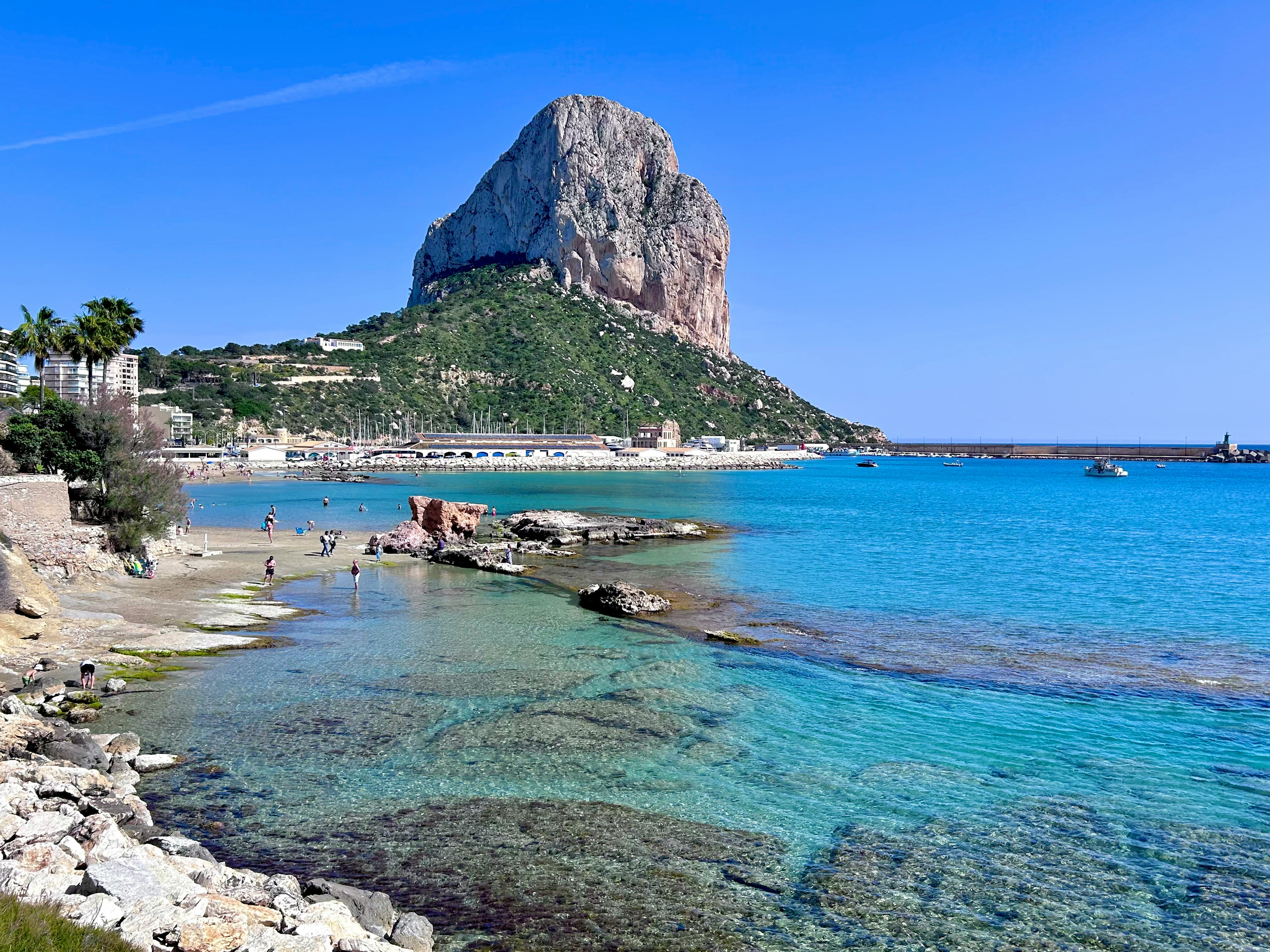 Peñón de Ifach from the coast of Calpe with turquoise Mediterranean waters, reference point of the Morro de Toix viewpoint
